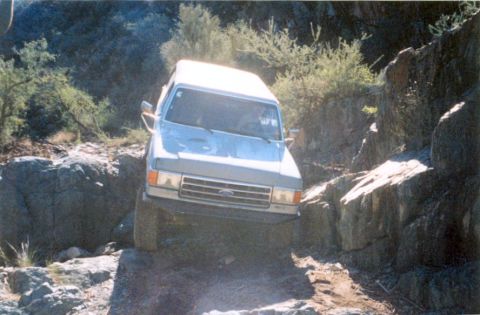 1990 Ford Bronco - This Ford Bronco is off-roading on a steep, rocky path.