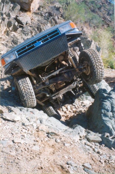 1990 Ford Bronco - This Ford Bronco is navigating a challenging rocky off-road course.