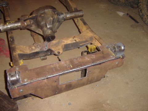1992 Ford Bronco - A close-up view of a vehicle's rear axle and frame components, showing signs of modification and wear.