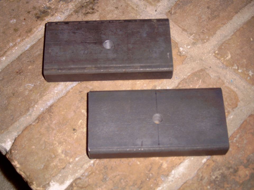 Shot shows plates cut and edges smoothed with a file. a 7/16 hole has been drilled in the very center to accept the new center pin bolt. I will sandwich this between the lower spring leaf and the Skyjacker pinion angle shim.