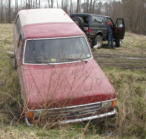 1988 Ford Bronco - Lessee? Doing doughnuts... slick clay road.... mud sogged cornfield.... and a ditch. Ashley got her stuck good.