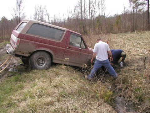 1988 Ford Bronco - Had to dig down in the muck and place a base pad for the hi-lift and to get a good grab on the side of the bumper.