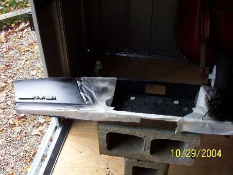 1999 Ford Crown Victoria - Car bumper with text taped off for painting, dated 10/29/2004.