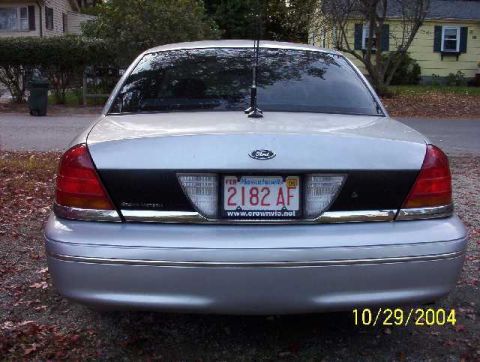1999 Ford Crown Victoria - Rear view of a silver Ford Crown Victoria, showing license plate and website on the frame.