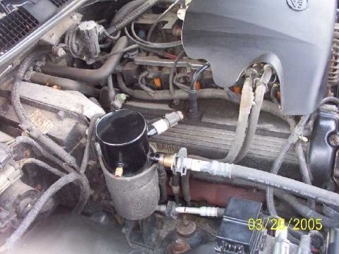 1999 Ford Crown Victoria - Close-up view of an engine bay, an aftermarket oil catch can and a timestamp of 03/20/2005.