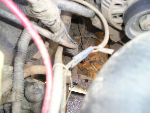 1996 Ford Bronco - A close-up view of the complex wiring and components within a vehicle's engine bay.