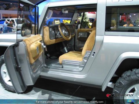 1995 Ford Bronco - Interior view of a concept SUV with tan upholstery and an open driver's door.