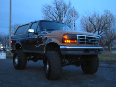 Lifted 1995 Ford Bronco with flame decals, 3q-front view