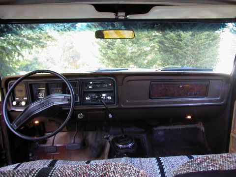1979 Ford Bronco - The dashboard of a vintage Ford truck, a wood-grain accent panel and a classic radio.