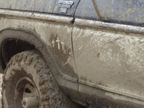 1992 Ford Bronco - Muddy 1992 Ford Bronco Ranger showing side panel and wheel after off-roading.