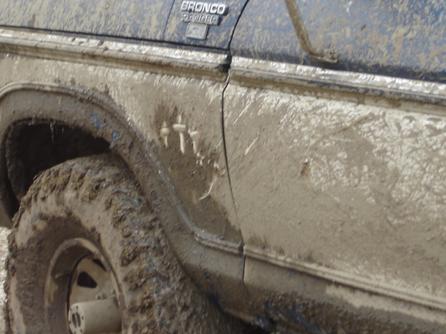 Mud-covered 1992 Ford Bronco Ranger side panel and wheel