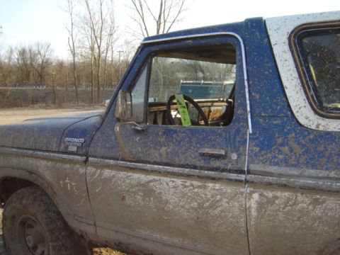 1992 Ford Bronco - This Ford Bronco is covered in mud, suggesting it has been used off-road.