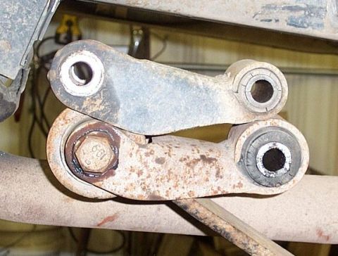 1986 Ford Ranger - Rear shackles; on top, stock Ranger shackle, below is GM shackle that came with my 63" rear springs. I used the GM shackle because of the l…