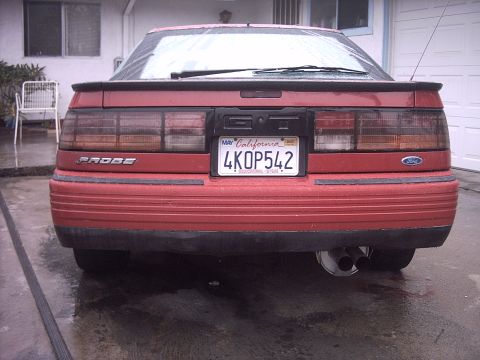 1989 Ford Probe - Rear view of a red 1989 Ford Probe GT, showing its distinctive taillights and spoiler.