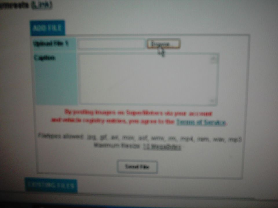 Computer screen displaying a file upload form with fields for 'Upload File 1' and 'Caption'
