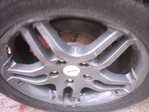 1989 Ford Probe - A close-up view of a car's wheel and brake caliper, with visible water droplets.