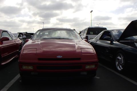 1989 Ford Probe - Front view of a red 1989 Ford Probe parked in a lot with other vehicles.