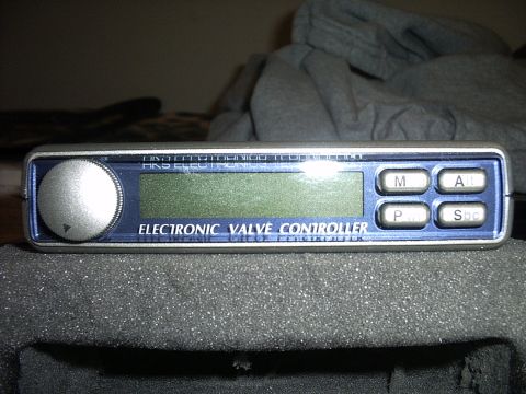 1989 Ford Probe - This electronic valve controller features a large dial, a digital screen, and four control buttons, likely an aftermarket automotive part.