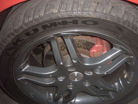 1989 Ford Probe - This image shows a close-up of a car's wheel, tire, and red brake caliper.