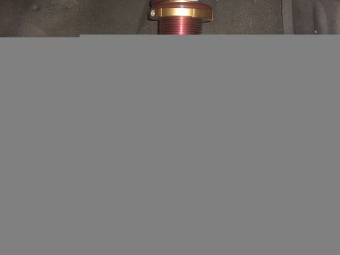 1989 Ford Probe - A close-up view of a single suspension coilover assembly, red and gold metallic components.