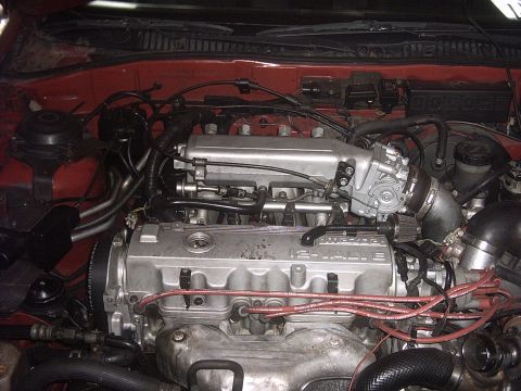 1989 Ford Probe - Close-up view of a vehicle's engine bay, highlighting the 16-valve engine components and wiring.