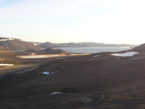 2001 Jeep Wrangler - A wide view of a desolate, mountainous terrain with a calm body of water in the distance.