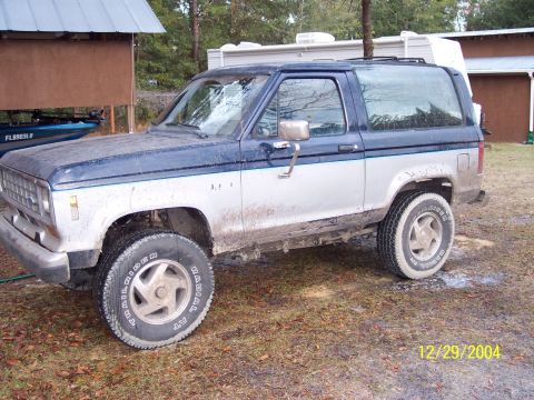 1993 Ford Bronco - This Ford Bronco II is covered in mud, suggesting it has been used off-road.