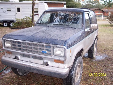 1993 Ford Bronco - This 1989 Ford Bronco II is shown from the front 3/4 angle, covered in dust.