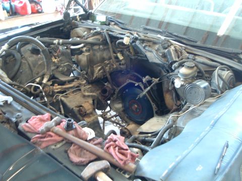 1989 Ford Crown Victoria LTD - Engine bay during removal, showing disassembled components and tools.