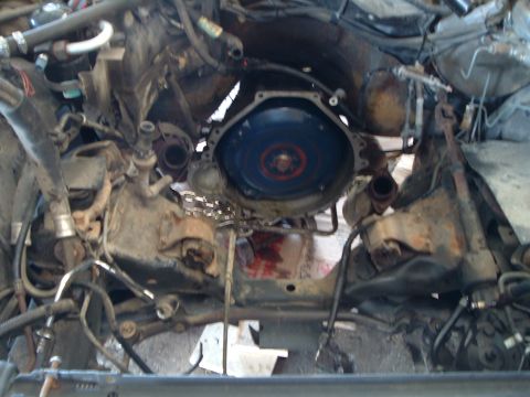 1989 Ford Crown Victoria LTD - The engine bay is exposed, revealing the transmission housing and surrounding mechanical parts.