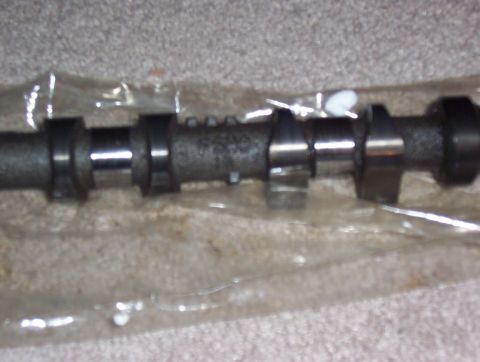 1997 Ford Probe - A camshaft is shown in its packaging, with some identifying numbers visible on the shaft.
