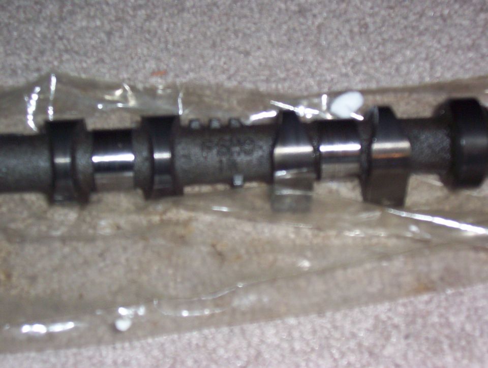 Camshaft with some numbers stamped on it, in plastic packaging