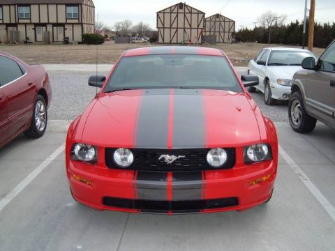 1978 Ford Mustang II - Front view of a red 2005 Ford Mustang with dual black racing stripes.