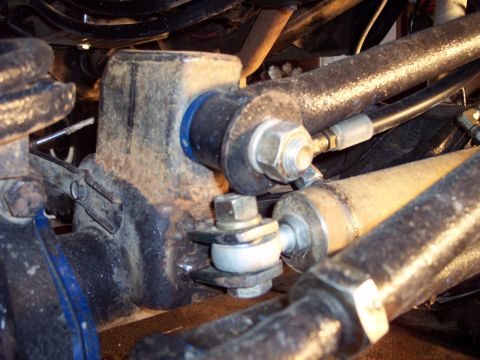 1974 Ford Bronco - This image shows a close-up view of a vehicle's steering linkage system, various metal components and fasteners.