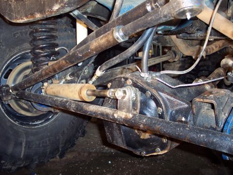 1974 Ford Bronco - Close-up view of a vehicle's suspension and drivetrain components.
