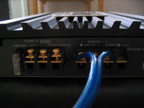 1993 Ford Taurus - Rear panel of a car amplifier with power and speaker connections visible.