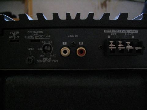 1993 Ford Taurus - Rear panel of a car amplifier shows various inputs and controls, including line in and speaker level outputs.