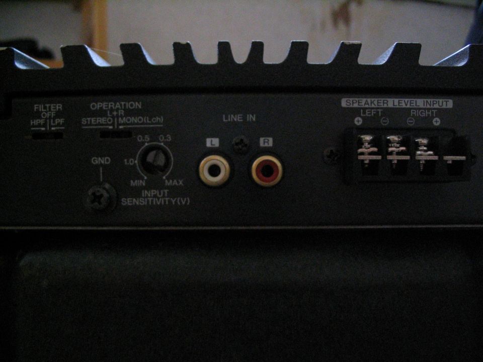 Car amp input panel with filter switches, gain knob, RCA jacks and speaker-level inputs
