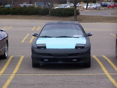 1993 Ford Probe - This 1993 Ford Probe features a distinctive light blue hood contrasting with its black body and pop-up headlights.