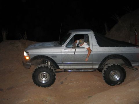 1993 Ford Bronco - This 1993 Ford Bronco is shown off-roading at night on a dirt track.