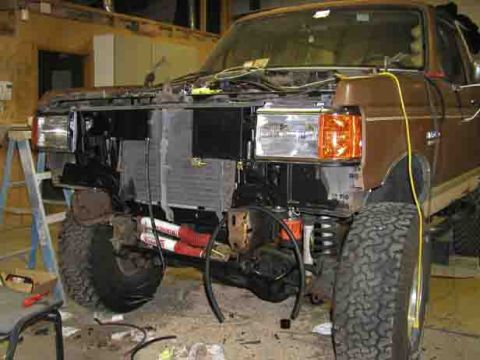 1988 Ford Bronco - Front end of a 1988 Ford Bronco is disassembled, revealing the radiator and engine components.