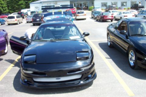 1993 Ford Probe - Two black Ford Probes are parked side-by-side in a parking lot on a sunny day.