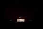 1993 Ford Probe - The rear of a vehicle is dimly lit at night, with the license plate being the only discernible feature.