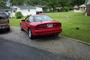 1993 Ford Probe - Rear view of a red coupe parked in a driveway. The vehicle does not appear to be a 1993 Ford Probe.