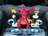 1993 Ford Probe - A red dragon figurine and two trophies are placed in the car's cupholders.