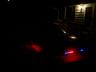 1993 Ford Probe - Rear view of a car at night, showing illuminated taillights.