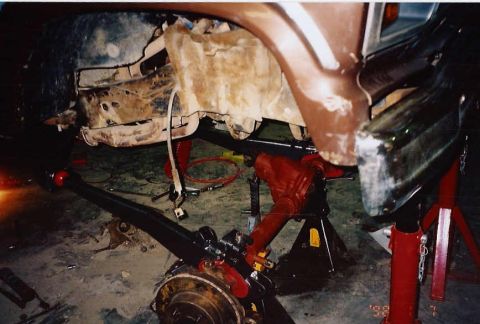 1984 Ford Bronco - This vehicle is undergoing front axle work, with the assembly clearly visible and supported by jack stands.
