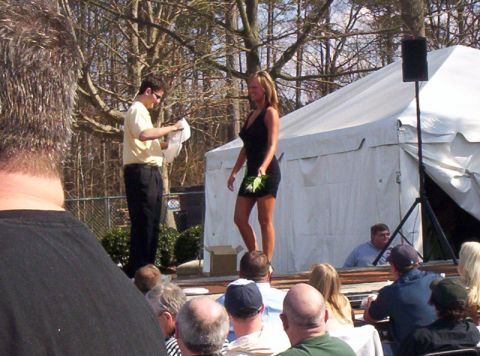 1986 Ford Bronco - A Hooters Bikini Contest event is underway with contestants on stage and an audience watching.