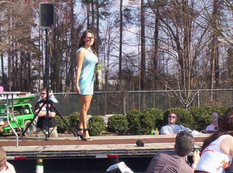 1986 Ford Bronco - A woman in a blue dress stands on a stage during an outdoor event.
