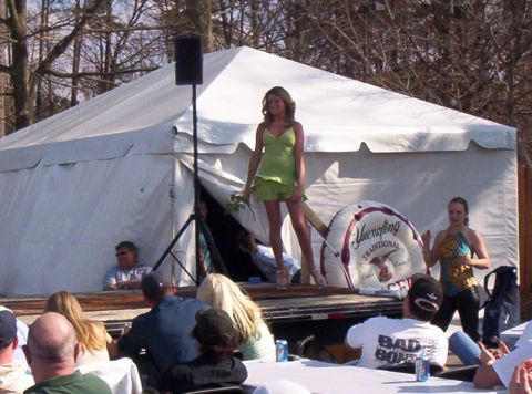 1986 Ford Bronco - An outdoor event is taking place with a woman on a stage and an audience watching.